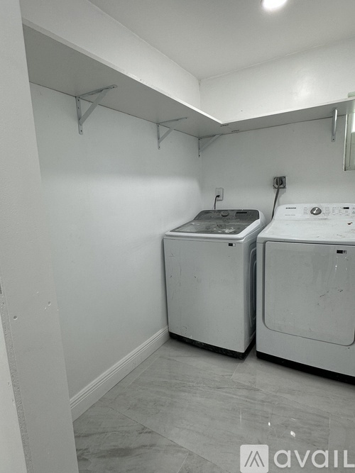 A laundry room with a washer and dryer.