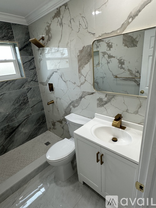 A bathroom with marble walls and a toilet.