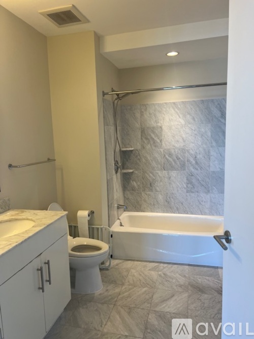 A bathroom with a toilet, sink, and bathtub.