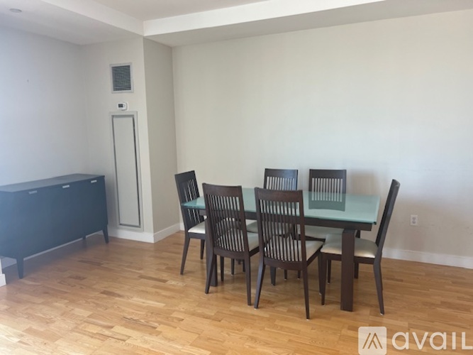 A dining room with a glass table and chairs.