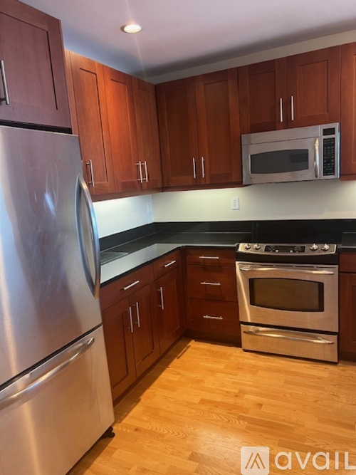 A kitchen with wooden cabinets and stainless steel appliances.