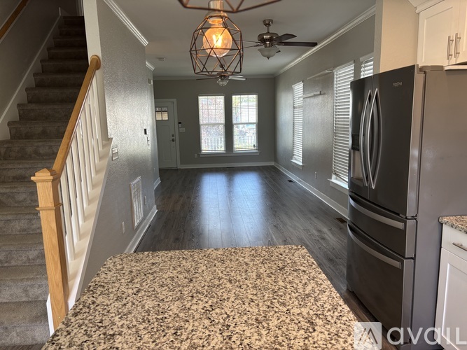 A kitchen with a granite countertop and a refrigerator.