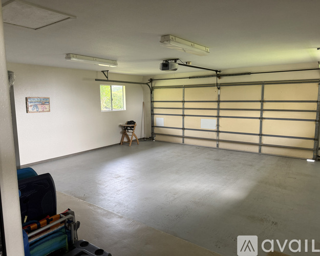 A spacious garage with a workbench and a window.