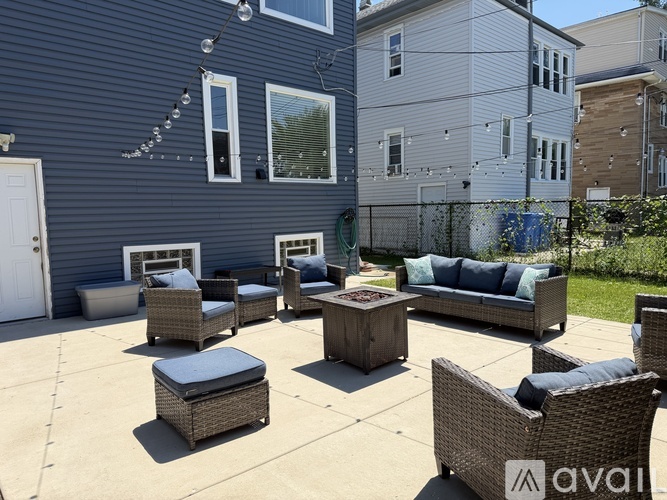 A patio with furniture and a blue wall.