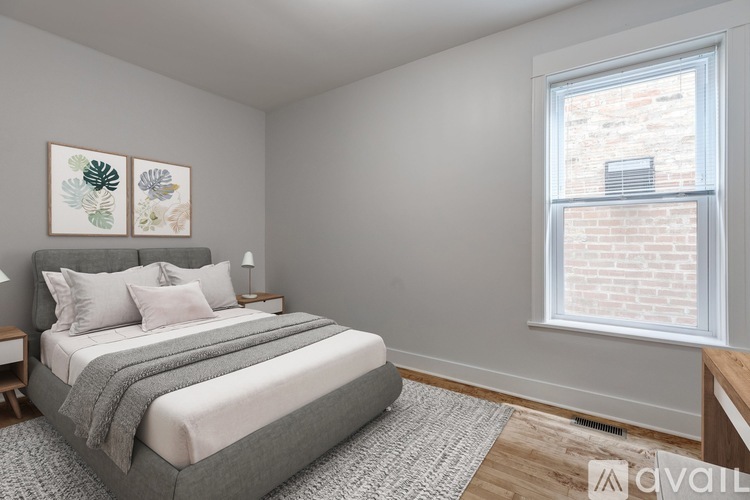 A bedroom with a large bed and a window.