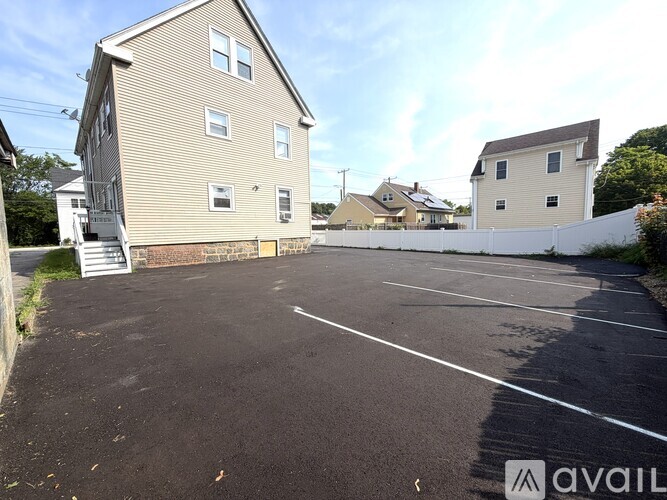 A parking lot with a building in the background.