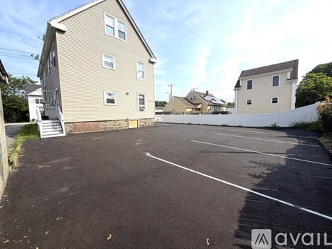 A parking lot with a building in the background.