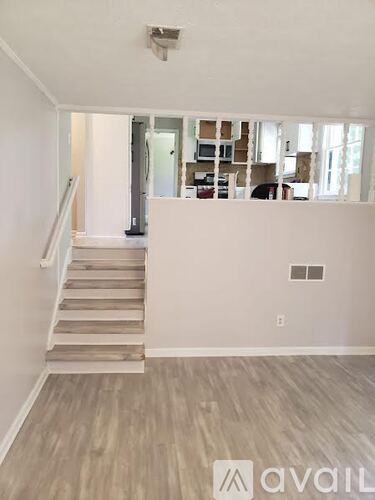A room with a staircase leading to the upper floor.