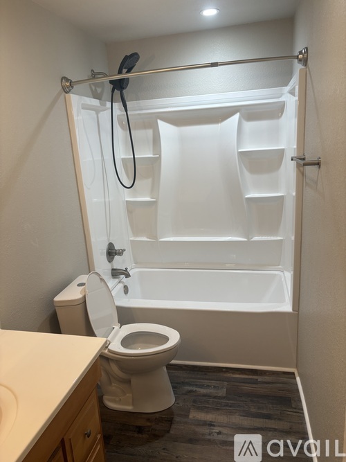 A white toilet and sink in a small bathroom.