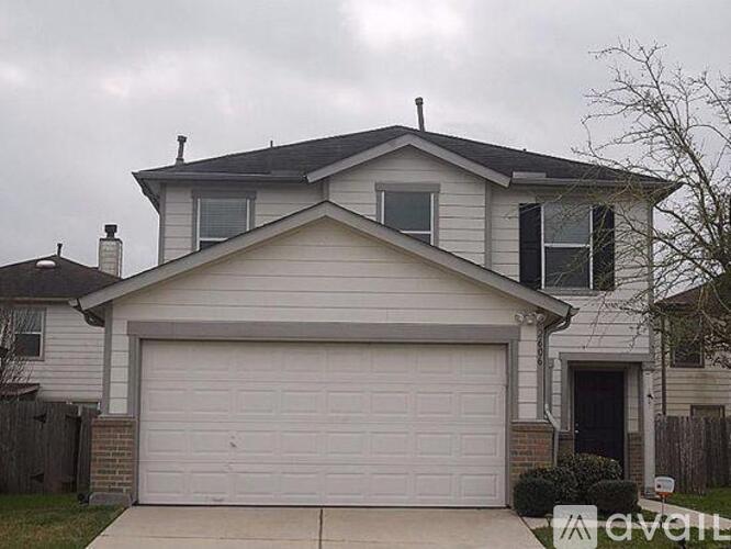 A two-story house with a garage is for sale.
