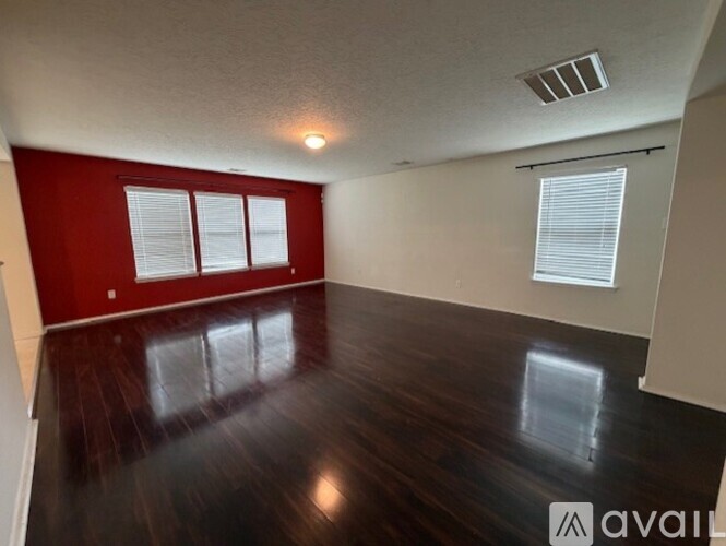 A room with wooden floors and red walls.