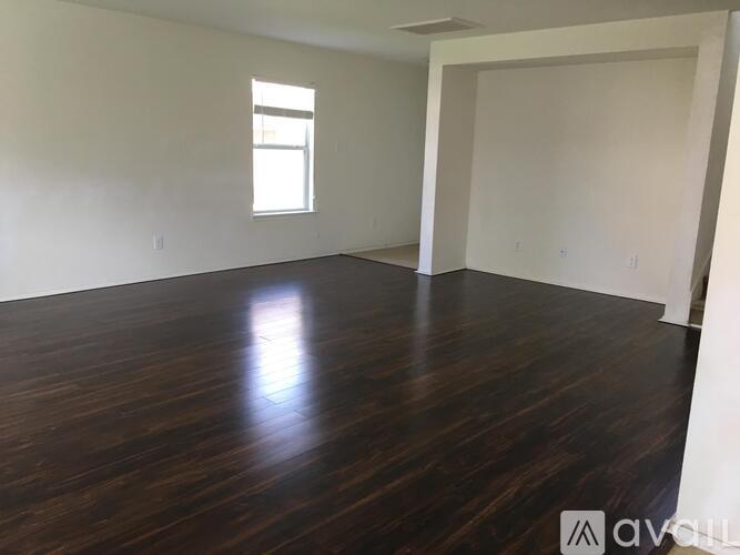 A room with wooden floors and a window.