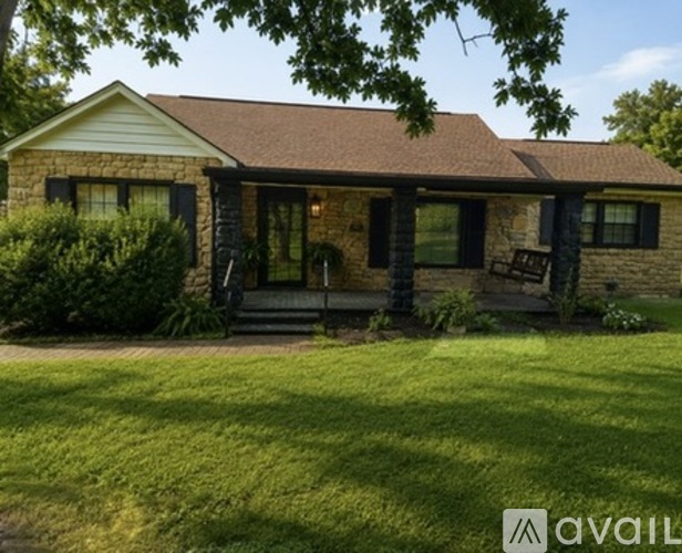 A house with a brown roof and a front porch.