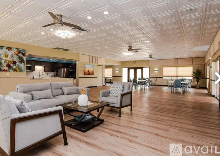 A living room with a grey sofa and a glass coffee table.