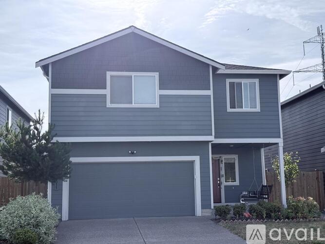 A two-story house with a garage is available for rent.
