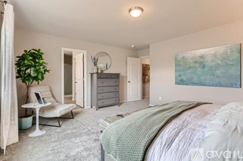 A bedroom with a large bed and a painting on the wall.