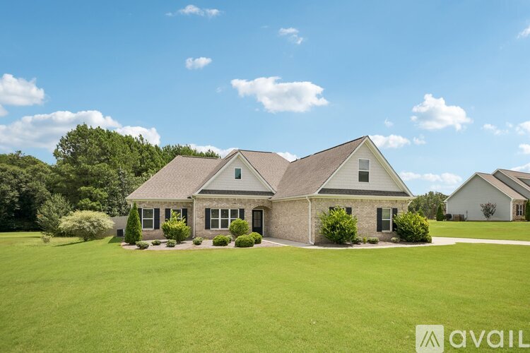 A house with a large lawn in front of it.