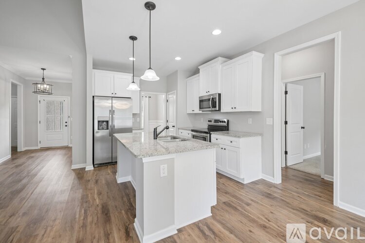 A modern kitchen with white cabinets and a central island.