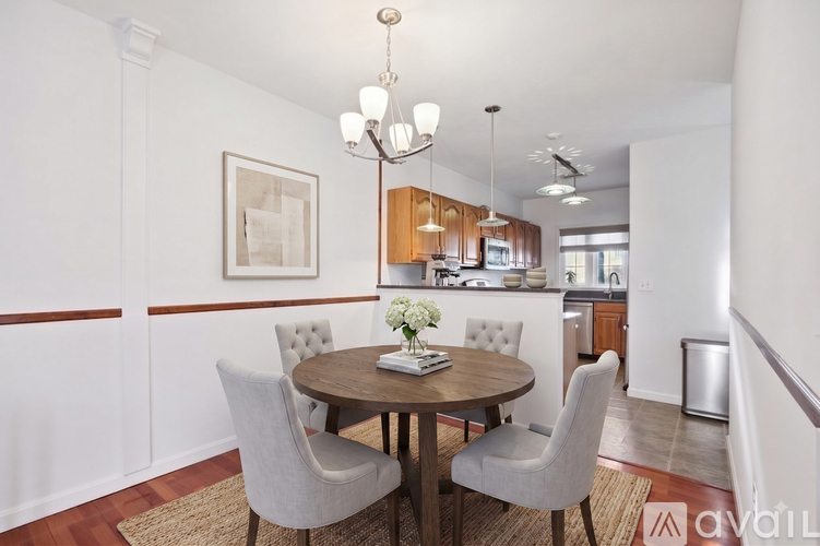 A dining room with a round table and chairs.