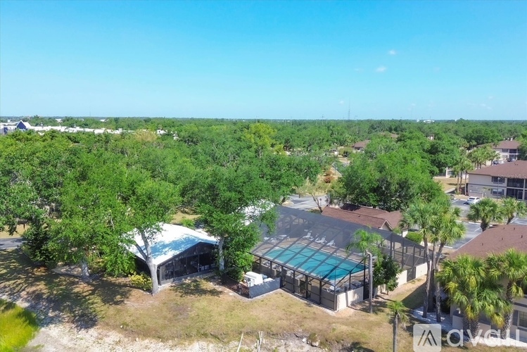 A bird's eye view of a residential area with houses and a swimming pool.