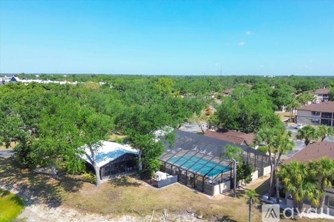 A bird's eye view of a residential area with houses and a swimming pool.