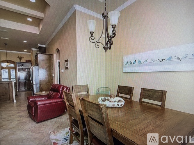 A dining room with a wooden table and chairs.