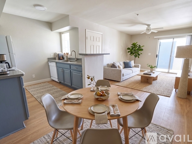 A modern dining room with a round table set for four.
