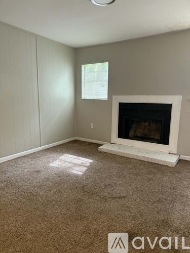 A room with a fireplace and a window.