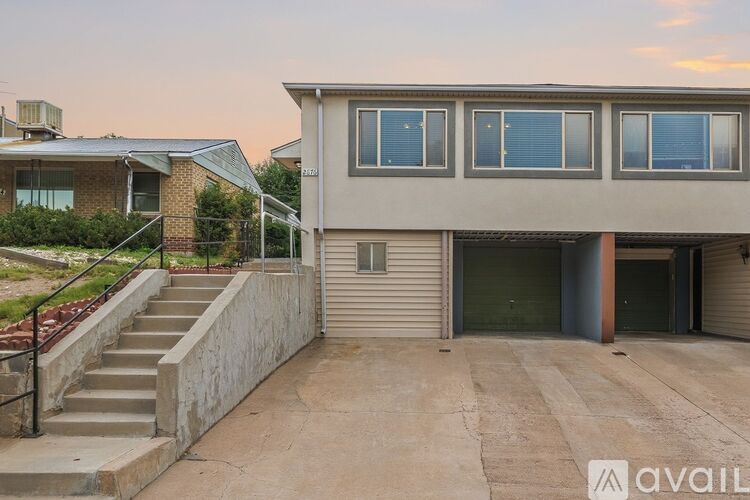 A house with a garage and a driveway in front.