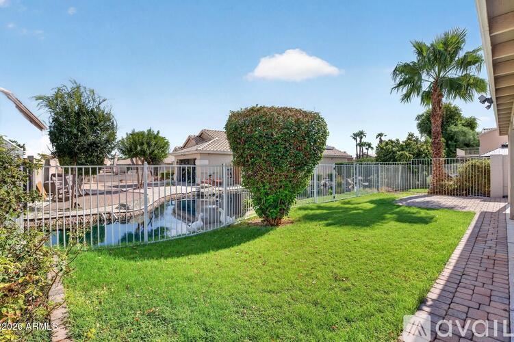 A backyard with a pool and a fence.