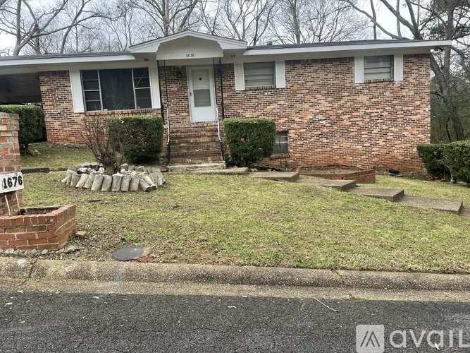 A brick house with a white door and windows.