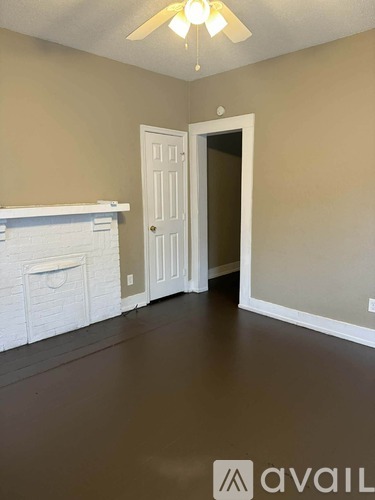 A room with a fireplace and a door.