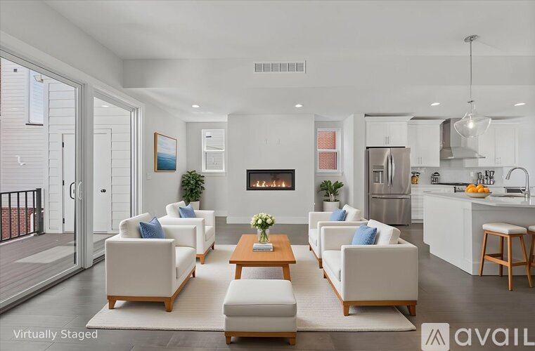 A modern living room with white furniture and a fireplace.