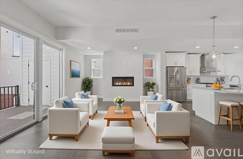 A modern living room with white furniture and a fireplace.