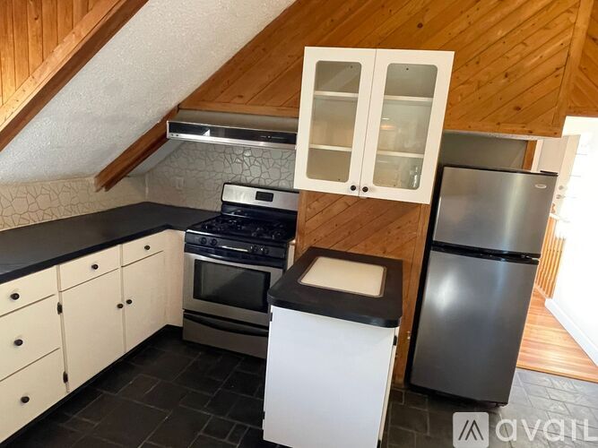 A kitchen with a stove, oven, and refrigerator.