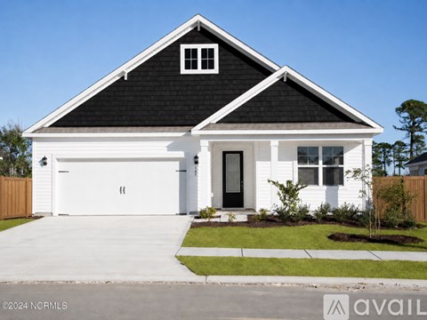 A white house with a black roof and a black door.