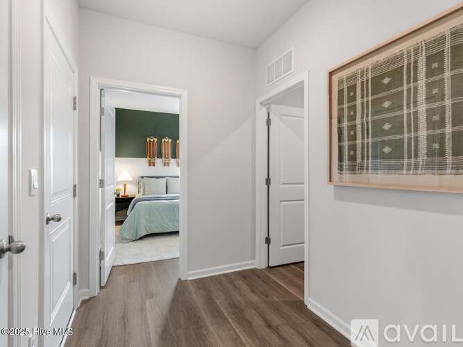 A bedroom with a bed and a painting on the wall.