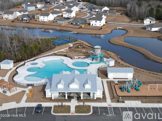 A bird's eye view of a residential area with a swimming pool and a waterfall.