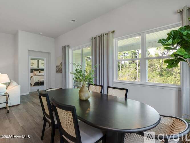 A dining room with a round table and chairs.