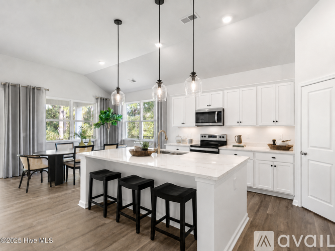 A modern kitchen with white cabinets and a central island.