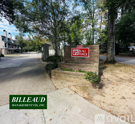 A sign for Beaulieu Ridge is displayed in front of a brick wall.