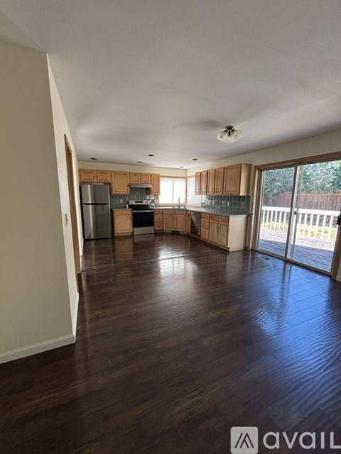A spacious kitchen with wooden floors and a large island.