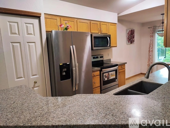 A kitchen with granite countertops and stainless steel appliances.