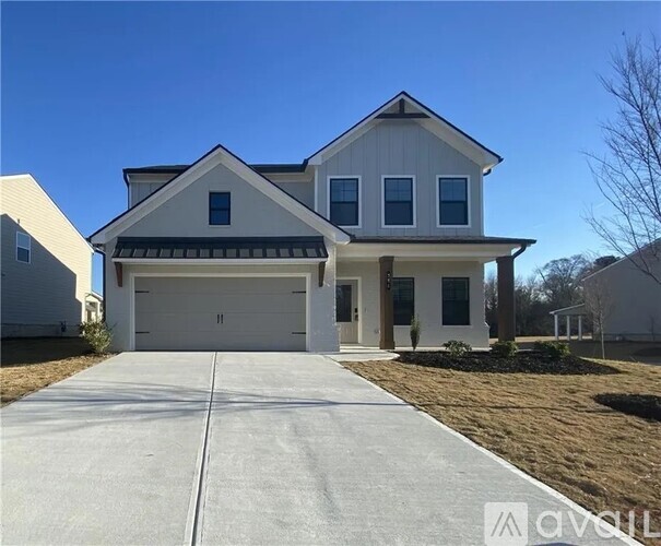 A two-story house with a garage is shown in the image.