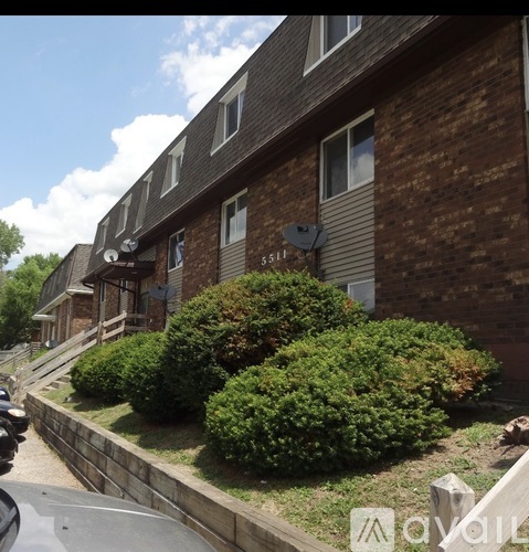 A brick building with a satellite dish on the roof.