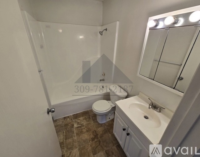 A bathroom with a toilet, sink, and mirror.