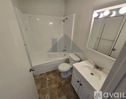 A bathroom with a toilet, sink, and mirror.