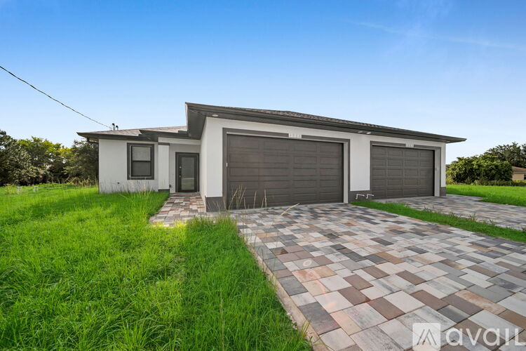 A modern house with a garage is for sale.