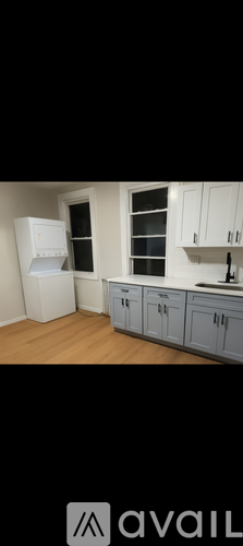 A kitchen with white appliances and cabinets.