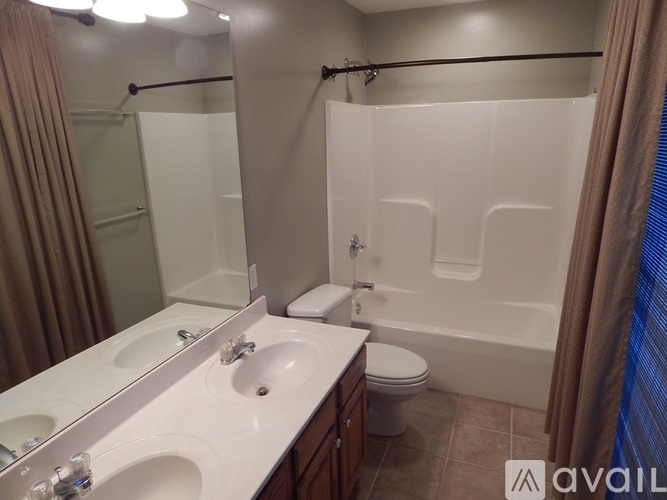 A bathroom with a white sink and a white toilet.